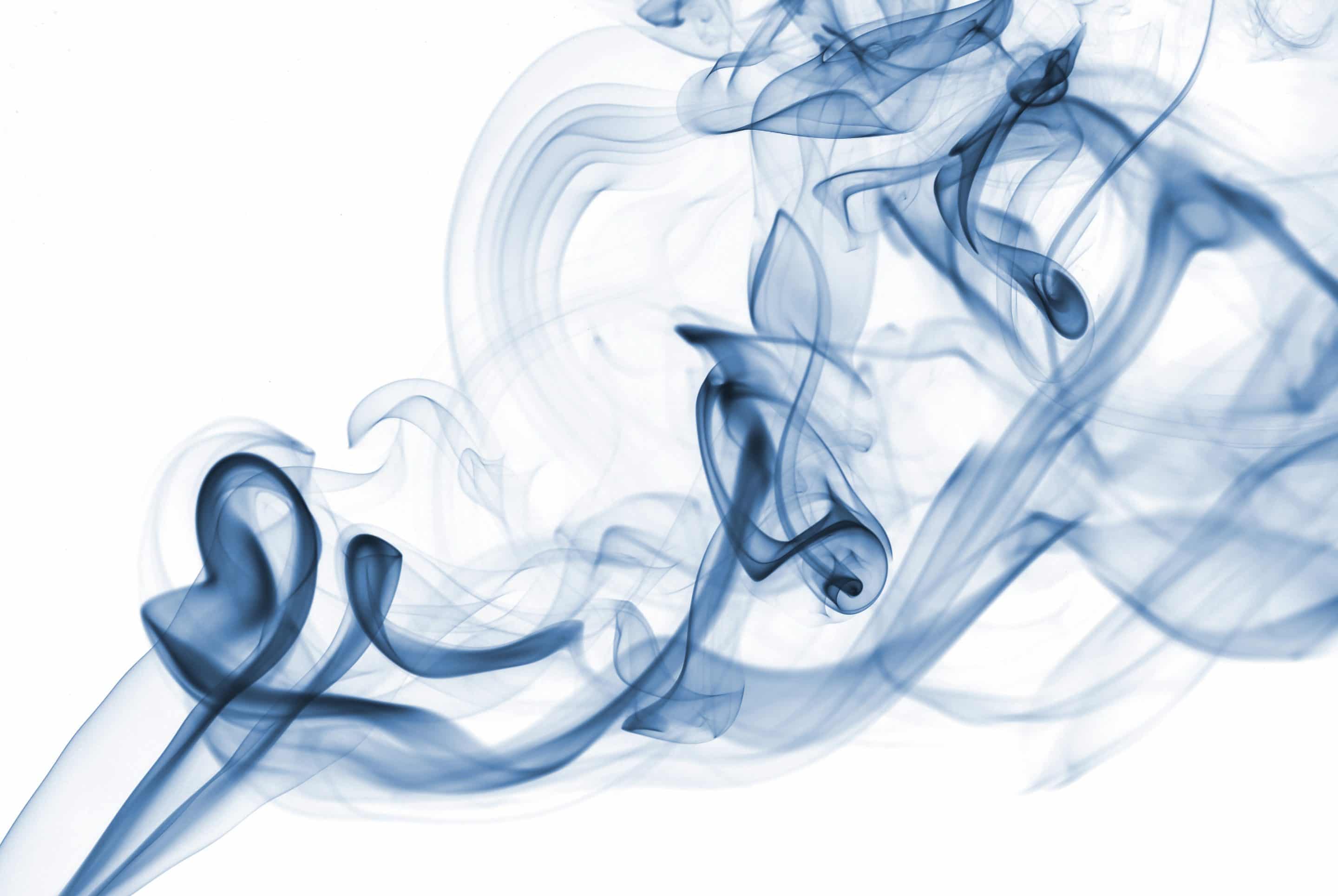 blue abstract smoke from the aromatic sticks on a white background.